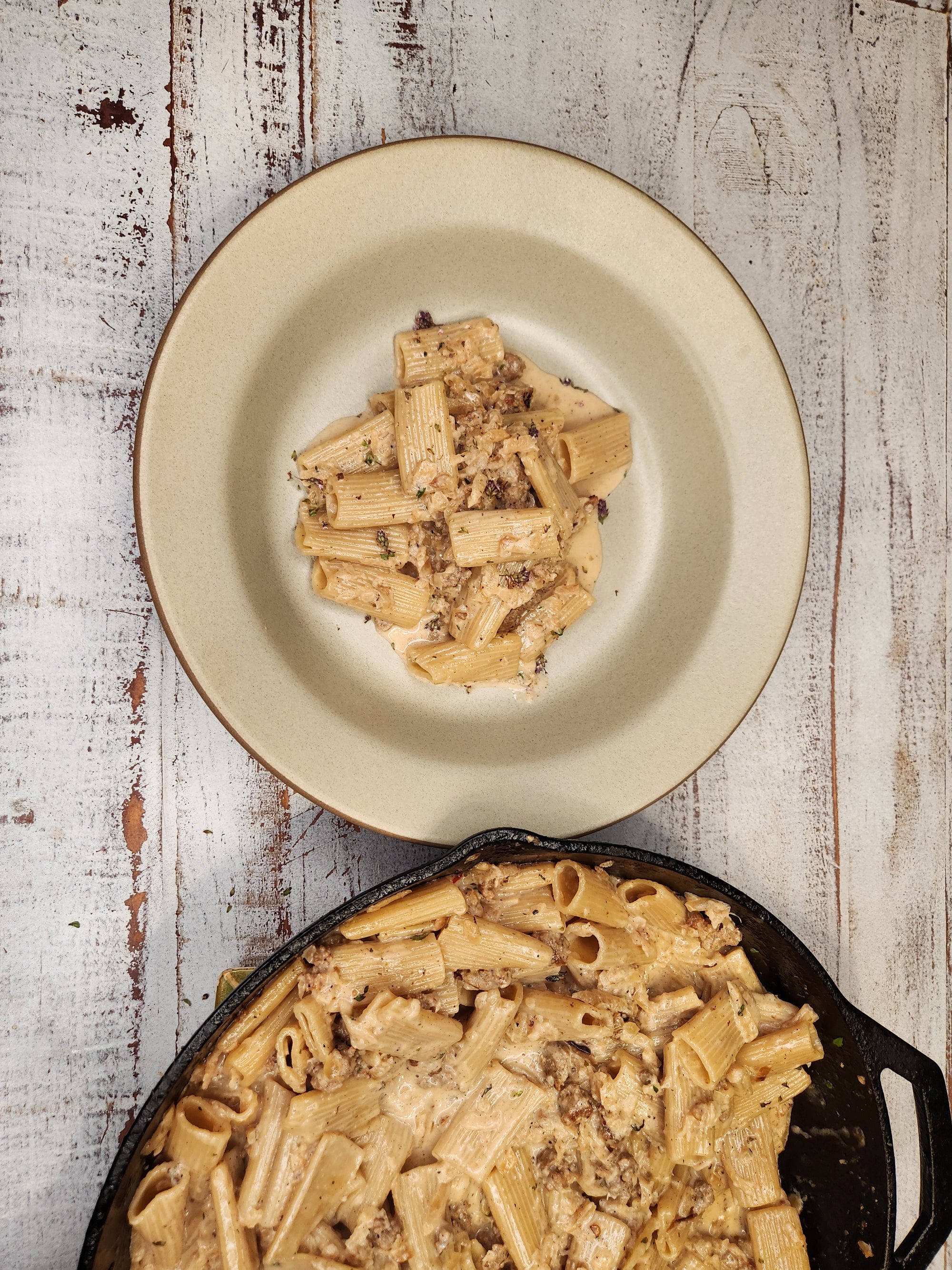 Rigatoni pasta in a root vegetable alla vodka sauce with sausage.