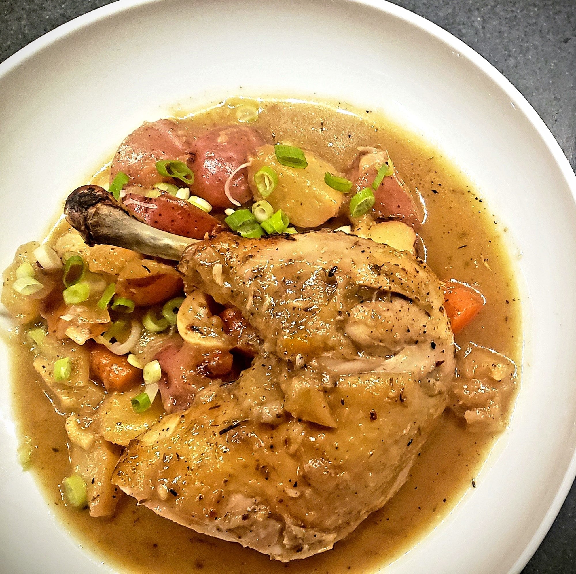roasted chicken in a chicken jus with braised potatoes. italian recipe. gluten free
